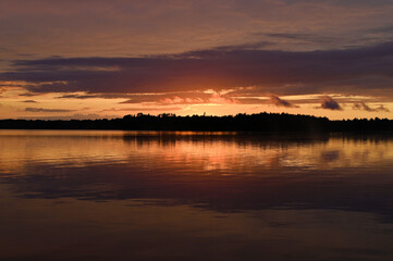 Naklejka na ściany i meble Red sky reflected in a lake at dusk 1