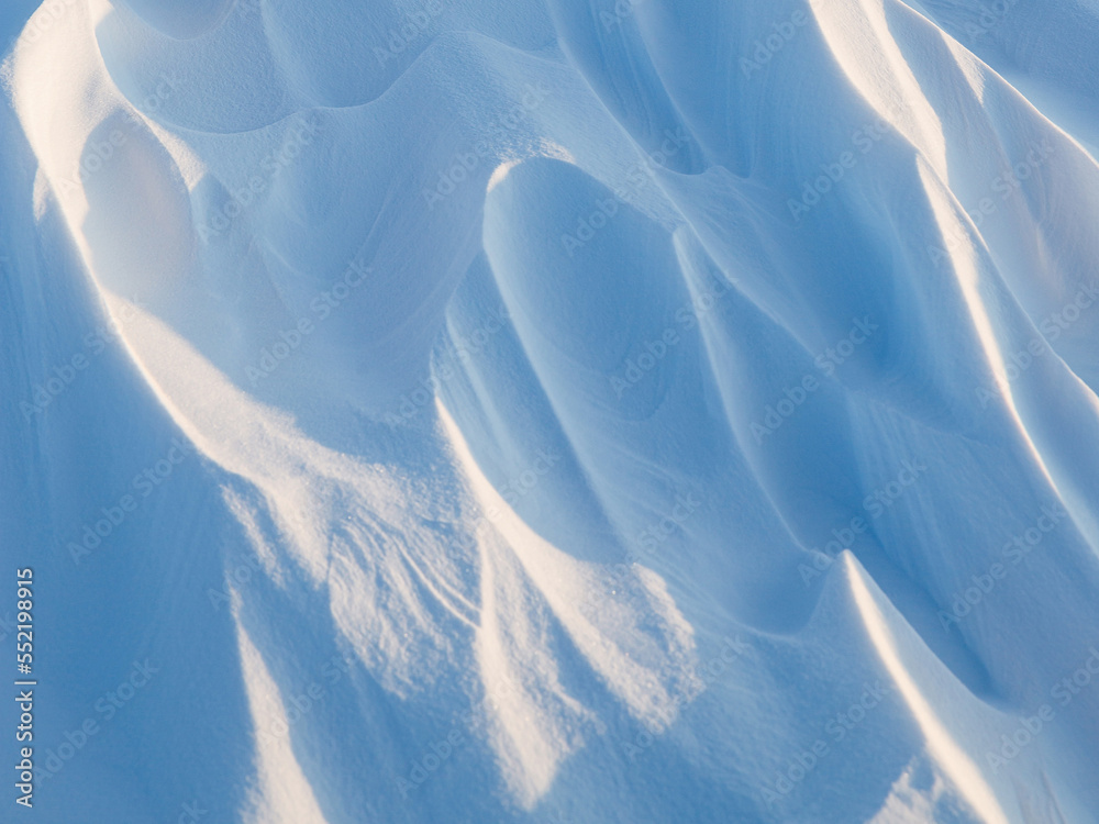 Wall mural snow texture. wind sculpted patterns on snow surface. wind in the tundra and in the mountains on the