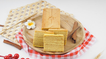 Traditional Indonesian sweet Lapis layer cake on wooden plate. Indonesian layered cake called 