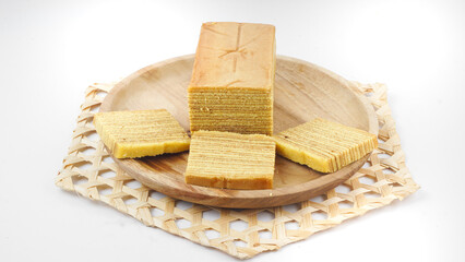 Traditional Indonesian sweet Lapis layer cake on a wooden plate. Selective focus
