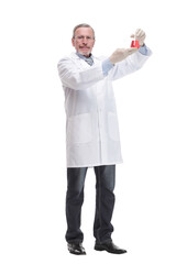 Portrait of a doctor wearing glasses and rubber gloves holding laboratory glassware beaker with red liquid substance