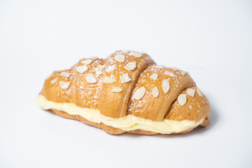 close up photo of a croissant with stuffing on a white background