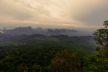 The view of the natural background of the mountain close-up, with blurred fog scattered in the rainy season or the humid climate, with beautiful green trees in the ecological system