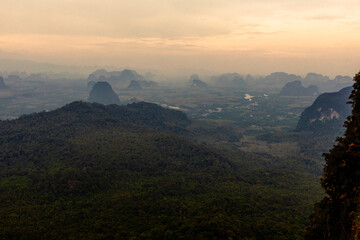 The view of the natural background of the mountain close-up, with blurred fog scattered in the rainy season or the humid climate, with beautiful green trees in the ecological system