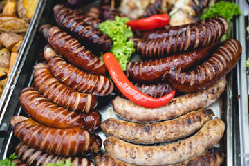 delicious grilled sausages with salad and vegetables