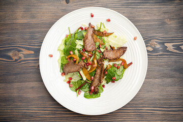 tasty and fresh meat salad on a plate in a restaurant from a chef.