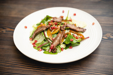 tasty and fresh meat salad on a plate in a restaurant from a chef.
