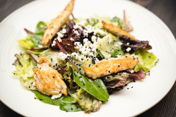 tasty and fresh meat salad on a plate in a restaurant from a chef.