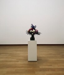 interior of a room with a vase and flowers. white room