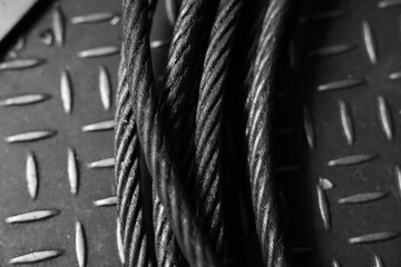 Iron wire rope placed on striped steel plate. Black and white photo. Conceptual images of...