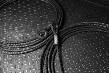 Iron wire rope placed on striped steel plate. Black and white photo. Conceptual images of...