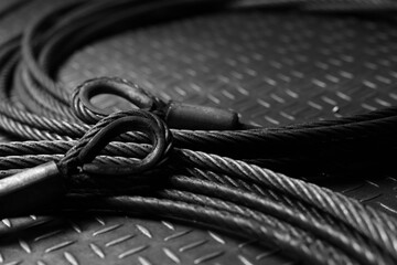 Iron wire rope placed on striped steel plate. Black and white photo. Conceptual images of...