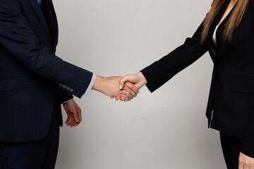 Businessman and woman shake hands as hello in office closeup. Friend welcome, introduction, greet or thanks gesture, product advertisement, partnership approval, arm, strike a bargain on deal concept