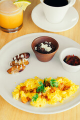 Healthy breakfast with coffee and orange juice at a restaurant table.