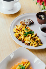 Egg and sausage breakfast at a restaurant table.