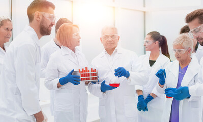 group of medical laboratory employees with medical flasks.