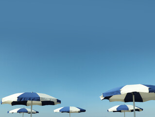 Beach umbrellas against blue sky on sunny day © New Africa