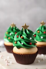 Christmas tree shaped cupcakes on marble board, closeup
