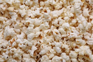 Tasty pop corn as background, top view