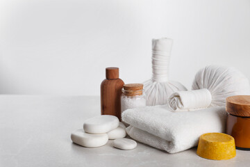 Fototapeta na wymiar Spa composition with care products on light grey marble table. Space for text