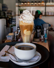 Close up photo of frappe and cup of coffee ready to serve