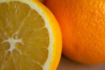 close-up half an orange on a light brown blurred background with orange