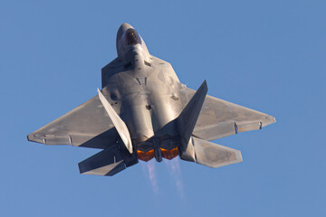 Close view of a F-22 Raptor in beautiful light ,  with afterburners on