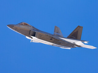 Very close view of a F-22 Raptor approaching in beautiful light