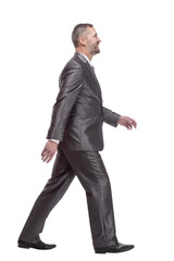 in full growth. confident business man striding forward.