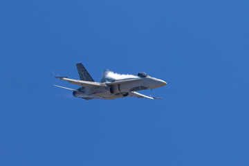 Very close frontal view of a F-18 Hornet in a high G maneuver, with condensation streaks around the  cockpit
