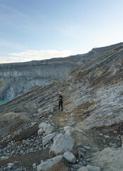 A woman walking at the top of mount Ijen in Banyuwangi, East Java, Indonesia.