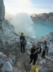 A woman walking at the top of mount Ijen in Banyuwangi, East Java, Indonesia.