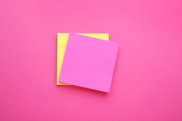 Obraz na płótnie Canvas Paper notes on pink background, top view