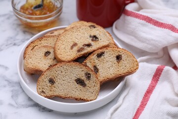 Sweet hard chuck crackers with raisins on white marble table