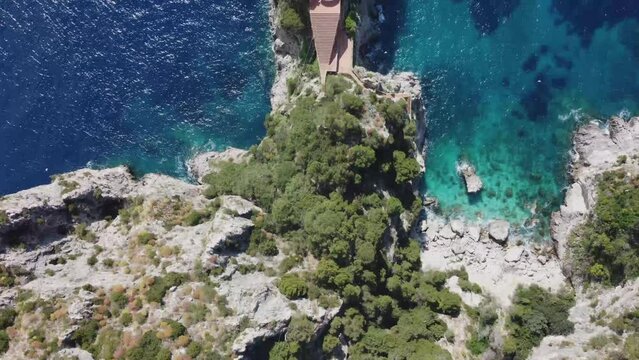 Rocky coastline and Malaparte Villa of Capri island, aerial top down view