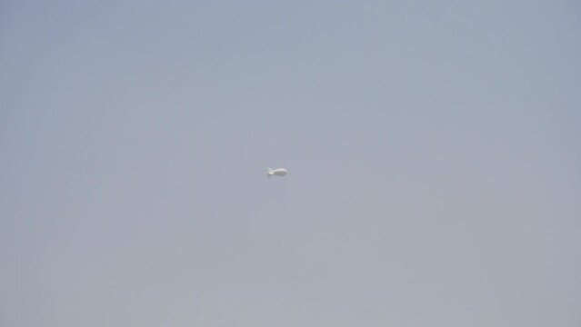 U.S. Government blimp flies high in the sky as it conducts surveillance in Kabul city