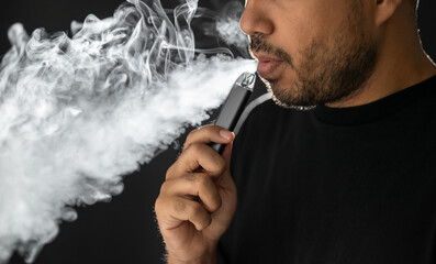 Close-up mouth of man smoke inhaling, breathing and smoke electronic cigarette.