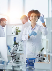 Smiling scientists looking at camera arms crossed in laboratory