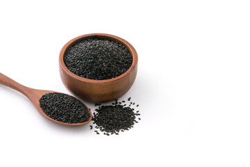 Black sesame seeds in wooden bowl and spoon isolated on white background.