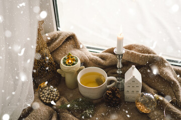 Christmas composition. Hot tea, candles, Christmas golden balls and decorations. Christmas holiday mood. Winter concept.