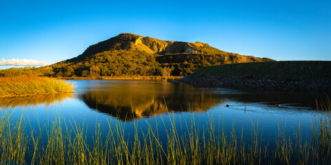 Lake Calaveras, volcanic Mt. Calavera, aqua plants, water reflections, tranquil landscape in Carlsbad, Southern California, USA