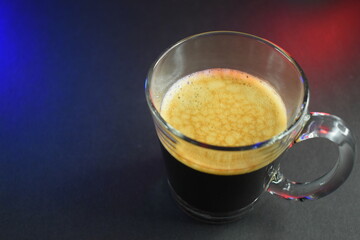black coffe on black table with neon lights
