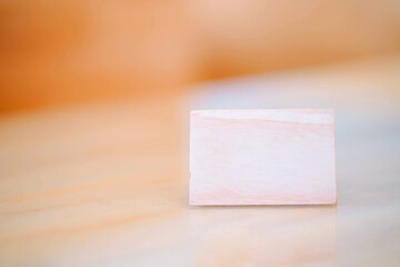 A small blank wooden plaque on the table. There is space for text.