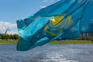The Kazakh flag flies over the Ishim River in the city of Astana