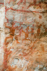 Close up view of 16,000 year old Aboriginal rock paintings of hunters at Zuojiang Huashan rock art site in Guangxi, China