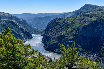 Aerial scenic view of Donnell Reservoir on Stanislaus River in Northern California. The deep blue waters surrounded by a steep rocky granite canyon.