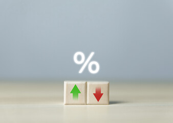 Wooden cube blocks with percentage icons and up or down arrows. Bank interest rates, stocks,...