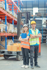 Portrait asian engineer in helmets order on tablet for checking goods and supplies on shelves with goods background in warehouse.logistic  business export ,Warehouse worker checking packages on store