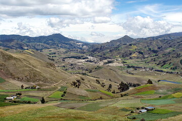 Fototapeta na wymiar Green, patchwork fields in a mountain valley in the Andes near Latacunga, Ecuador