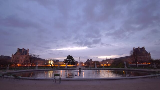 Evening view on Park with fountain near Louvre Museum square with Pyramid. Places of interest in Paris, France. Beautiful French architecture. Threes. Tourism, famous destinations. 4k footage